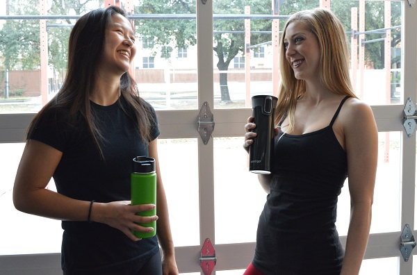 Female Athletes Drinking Water and Laughing